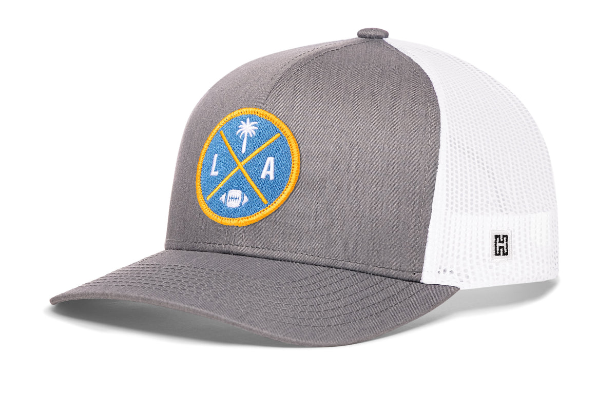 Los Angeles Football Trucker Hat, gray-white snapback showing Haka brandmark on left side of cap.