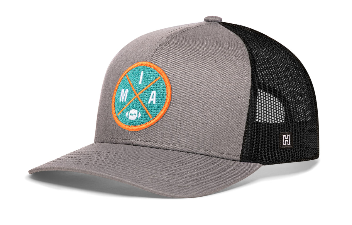 Miami Football Trucker Hat, gray-black snapback showing Haka brandmark on left side of cap.