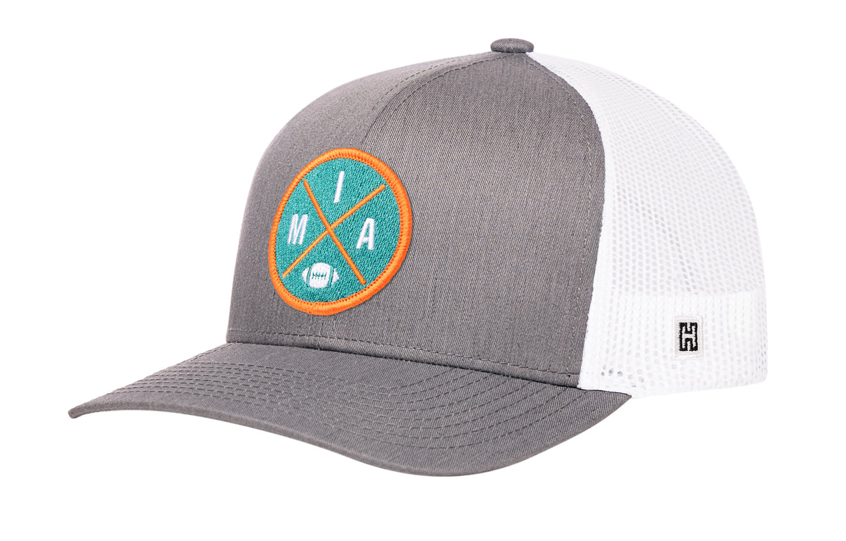 Miami Football Trucker Hat, gray-white snapback showing Haka brandmark on left side of cap.