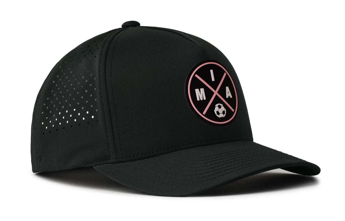 black performance 5-panel hat viewed from the right side, showcasing a bold black and pink pvc patch prominently displayed on the front