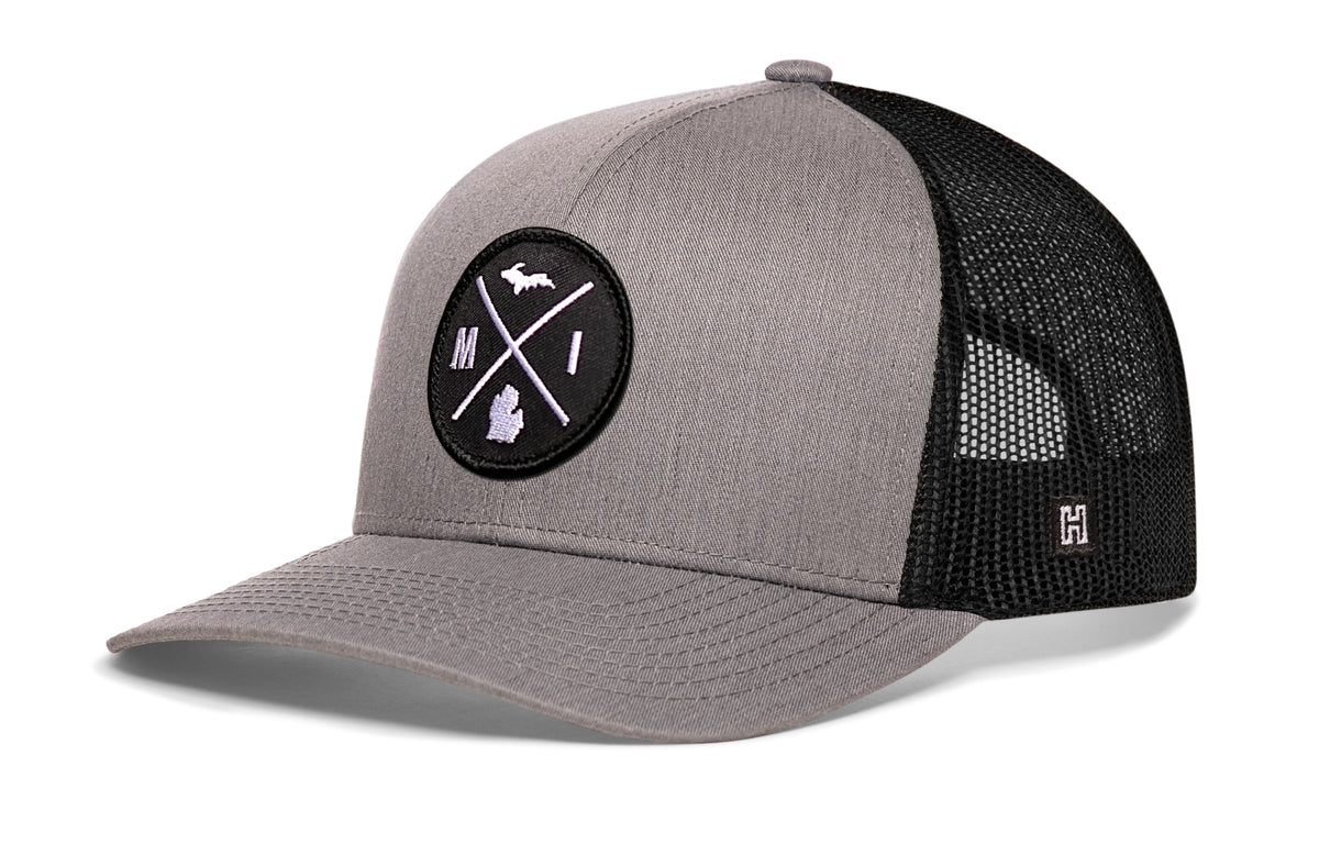 Michigan Trucker Hat, gray-black snapback showing Haka brandmark on left side of cap.
