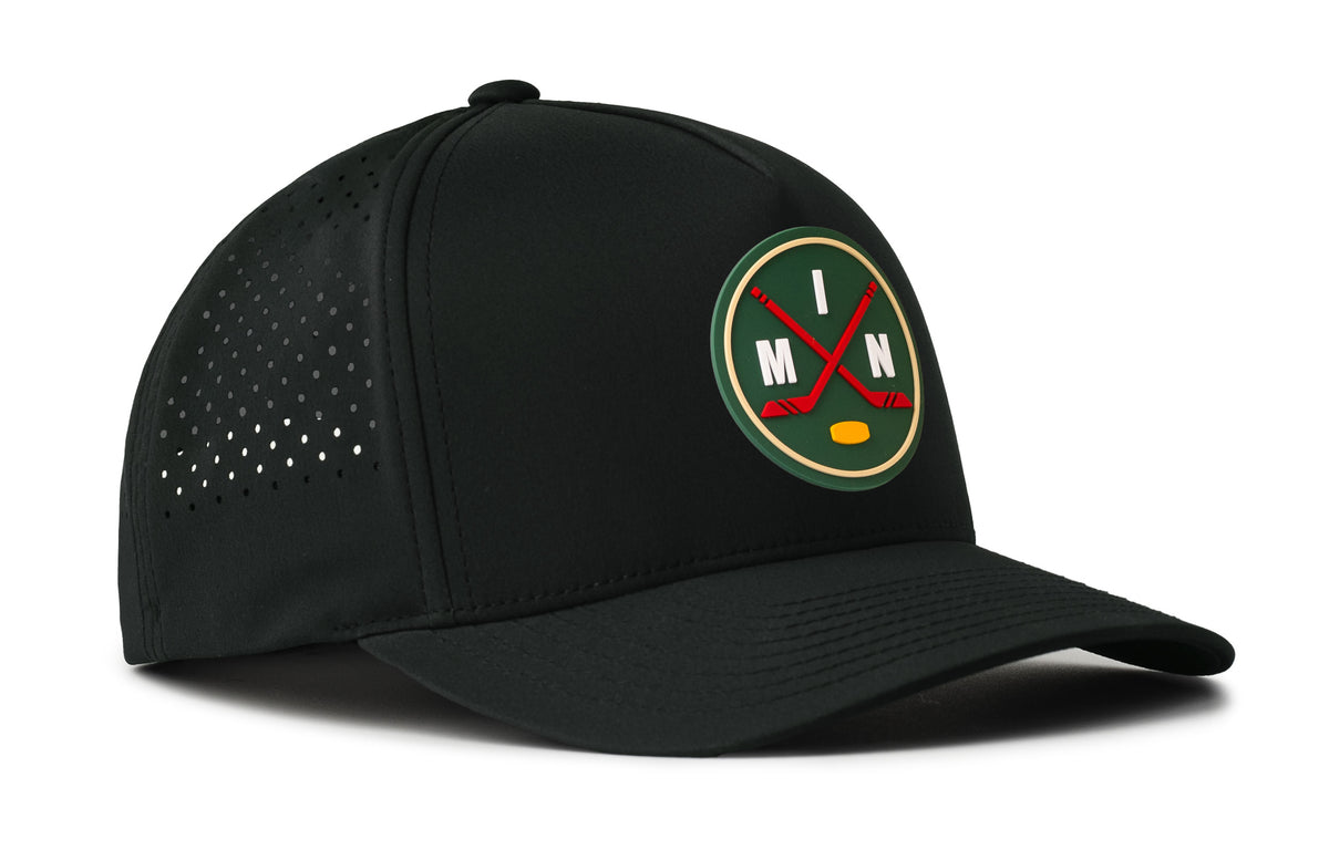 black performance 5-panel hat viewed from the right side, showcasing a bold green, red and gold pvc patch prominently displayed on the front