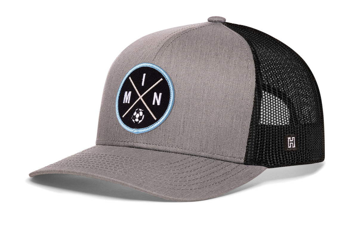 Minnesota Soccer Trucker Hat, gray-black snapback showing Haka brandmark on left side of cap.