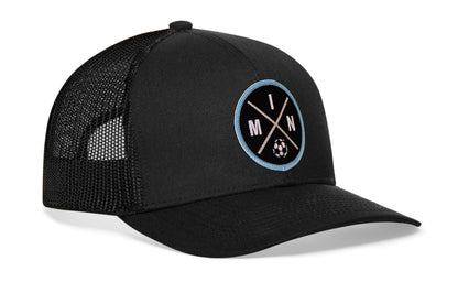 black trucker hat viewed from the right side, showcasing a bold black and blue embroidered X patch prominently displayed on the front