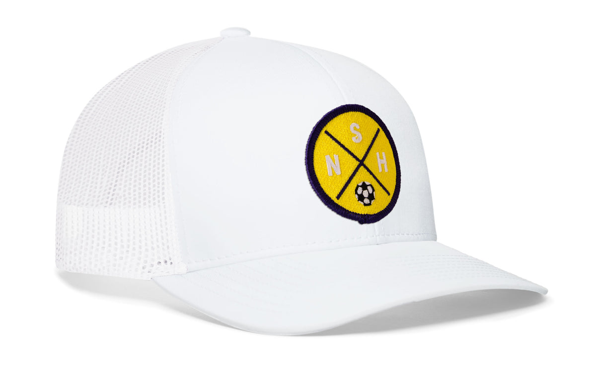 white trucker hat viewed from the right side, showcasing a bold yellow and blue embroidered X patch prominently displayed on the front