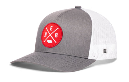 Nebraska Trucker Hat, gray-white snapback showing Haka brandmark on left side of cap.