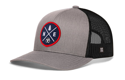 New England Soccer Trucker Hat, gray-black snapback showing Haka brandmark on left side of cap.
