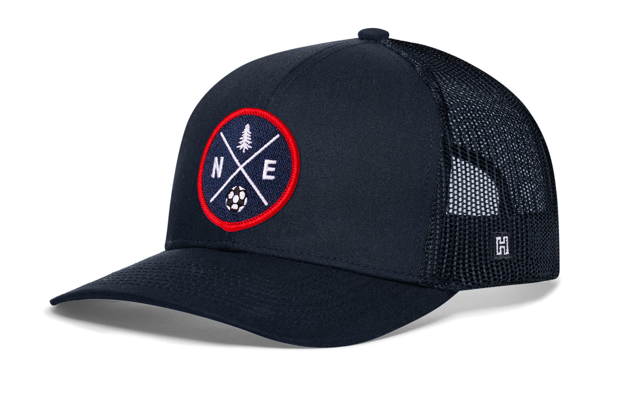 New England Soccer Trucker Hat, navy snapback showing Haka brandmark on left side of cap.