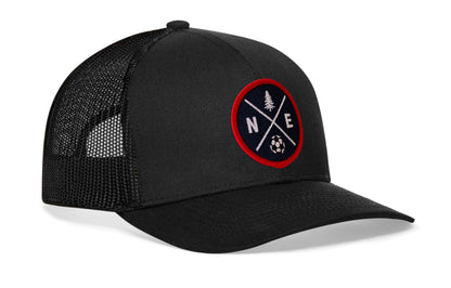black trucker hat viewed from the right side, showcasing a bold red and blue embroidered X patch prominently displayed on the front