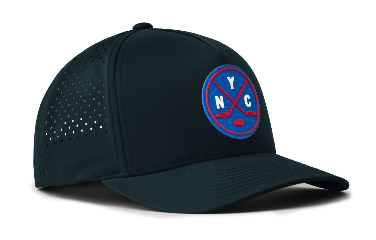 navy performance 5-panel hat viewed from the right side, showcasing a bold royal and red pvc patch prominently displayed on the front