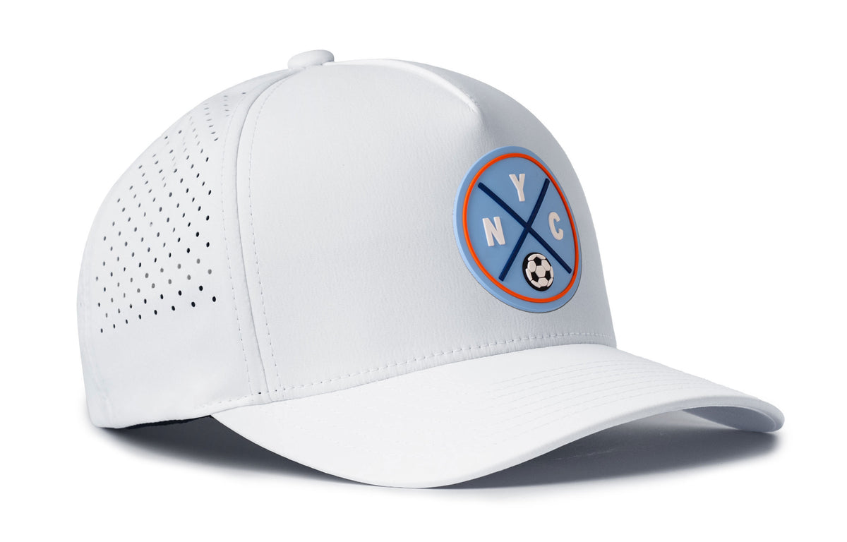 white performance 5-panel hat viewed from the right side, showcasing a bold sky blue and orange pvc patch prominently displayed on the front