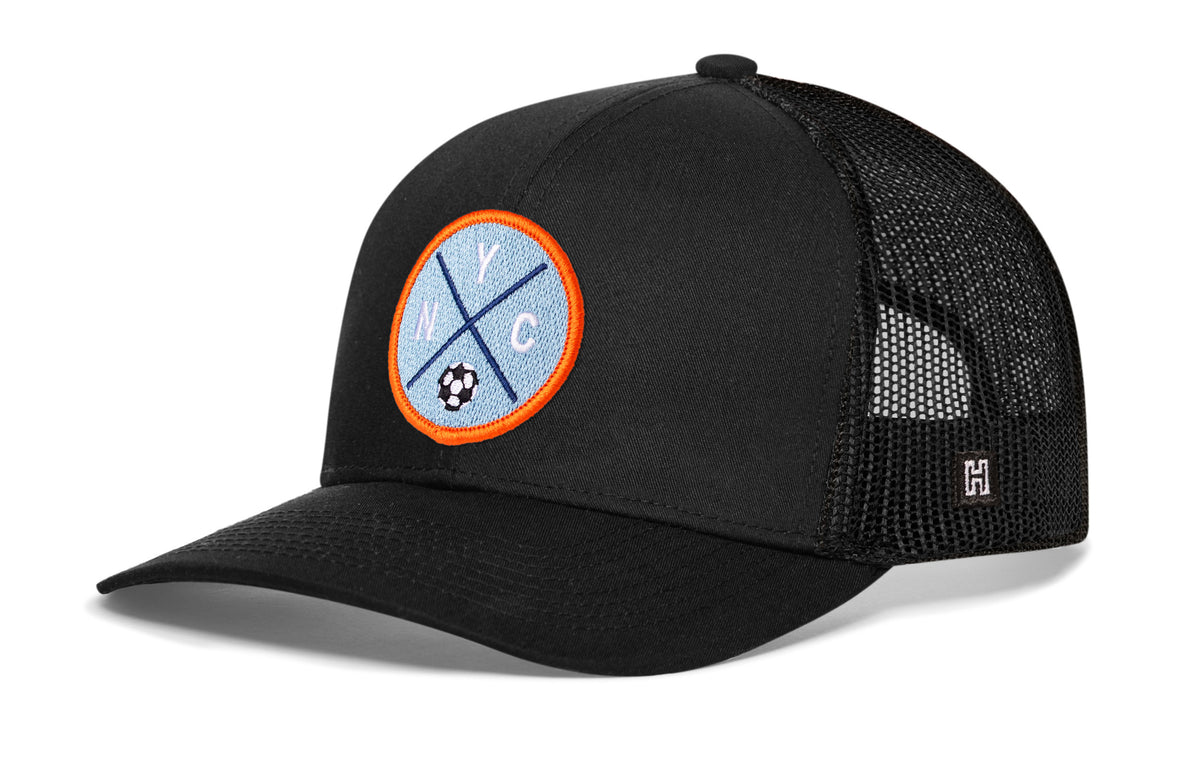 New York City Soccer Trucker Hat, black snapback showing Haka brandmark on left side of cap.