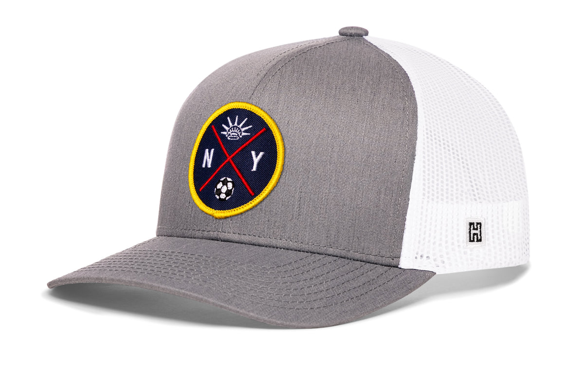 New York City Soccer Trucker Hat, gray-white snapback showing Haka brandmark on left side of cap.