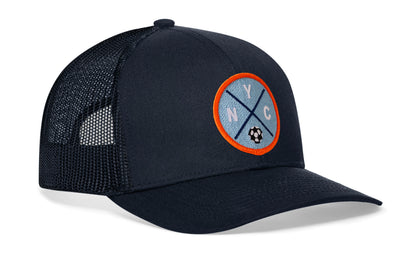 navy trucker hat viewed from the right side, showcasing a bold sky blue and orange embroidered X patch prominently displayed on the front