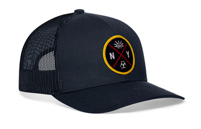 navy trucker hat viewed from the right side, showcasing a bold sky blue and orange embroidered X patch prominently displayed on the front