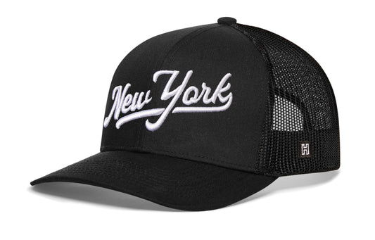 New York Trucker Hat, black snapback showing Haka brandmark on left side of cap.