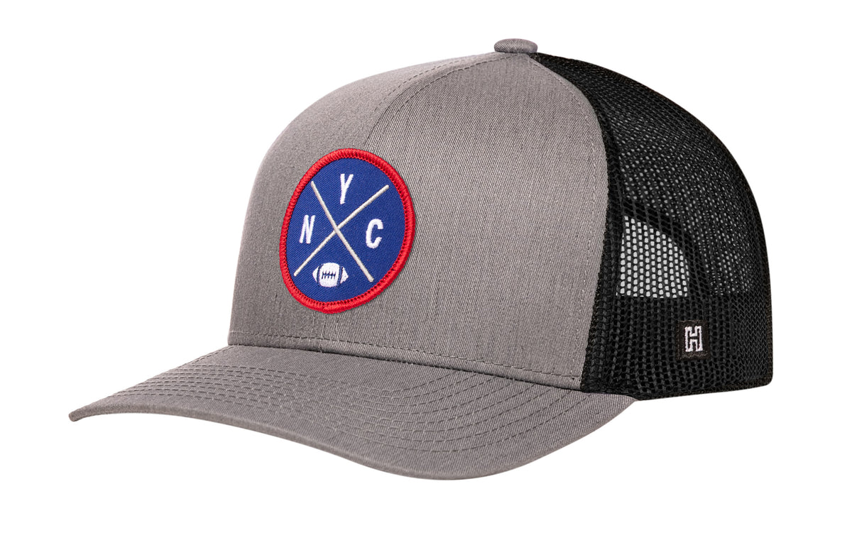 New York Football Trucker Hat, gray-black snapback showing Haka brandmark on left side of cap.