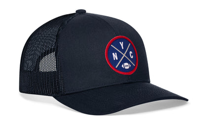 navy trucker hat viewed from the right side, showcasing a bold blue, silver and red embroidered X patch prominently displayed on the front