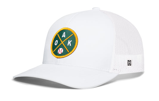 Oakland Baseball Trucker Hat, white snapback showing Haka brandmark on left side of cap.
