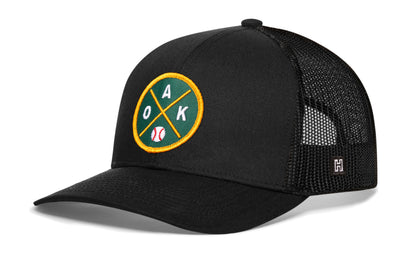 Oakland Baseball Trucker Hat, black snapback showing Haka brandmark on left side of cap.