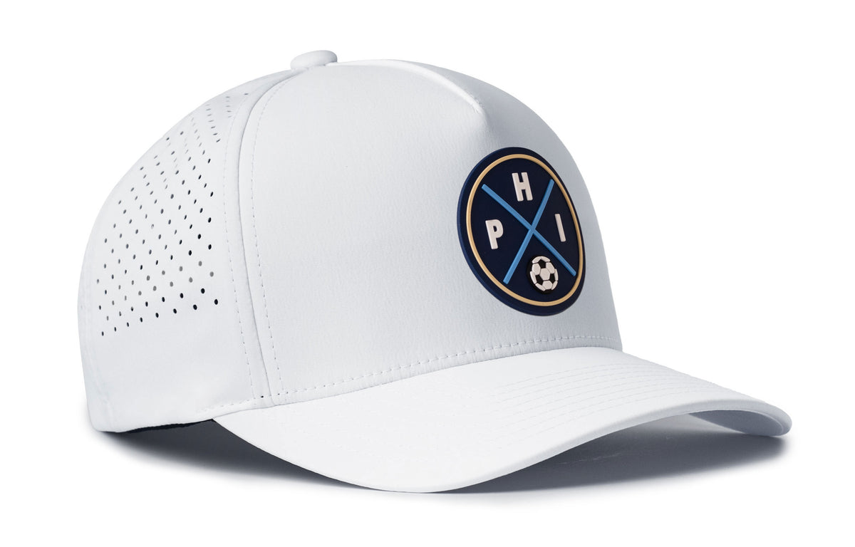 white performance 5-panel hat viewed from the right side, showcasing a bold navy and gold pvc patch prominently displayed on the front