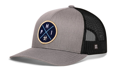 Philadelphia Soccer Trucker Hat, gray-black snapback showing Haka brandmark on left side of cap.
