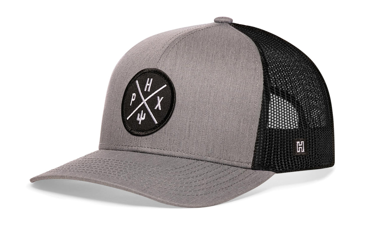 Phoenix Trucker Hat, gray-black snapback showing Haka brandmark on left side of cap.