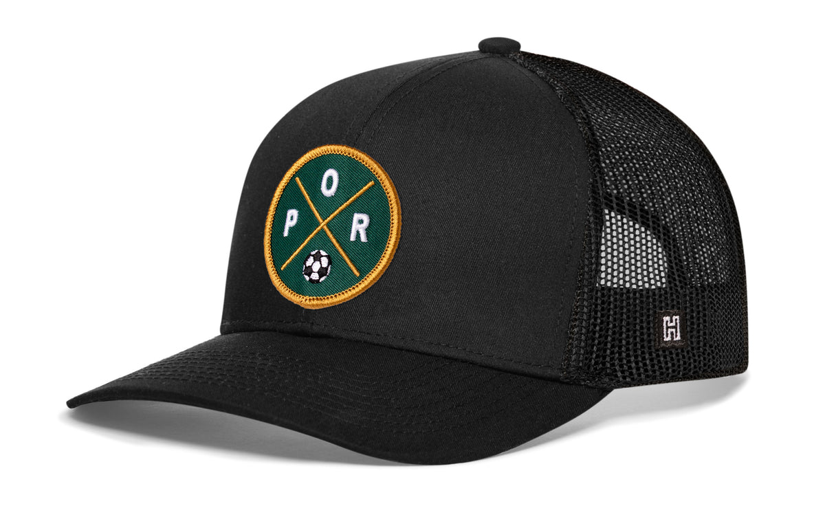 Portland Soccer Trucker Hat, black snapback showing Haka brandmark on left side of cap.