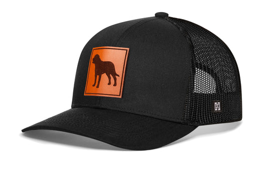 Rottweiler Trucker Hat, black snapback showing Haka brandmark on left side of cap.