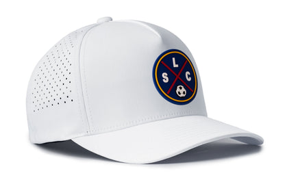 white performance 5-panel hat viewed from the right side, showcasing a bold deep red and blue pvc patch prominently displayed on the front