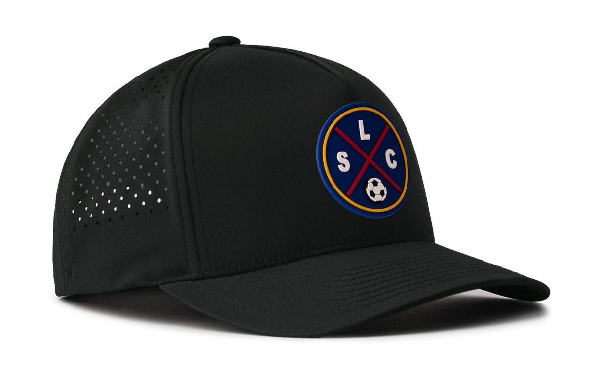 black performance 5-panel hat viewed from the right side, showcasing a bold deep red and blue pvc patch prominently displayed on the front