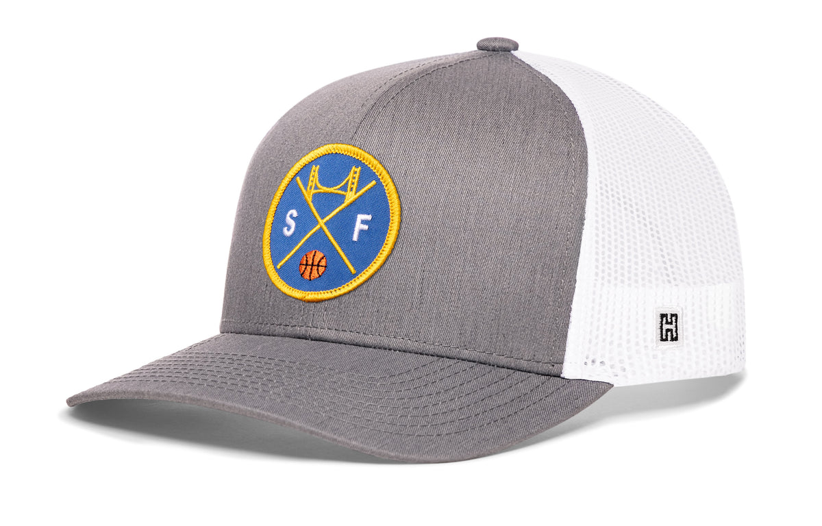 San Francisco Basketball Trucker Hat, gray-white snapback showing Haka brandmark on left side of cap.