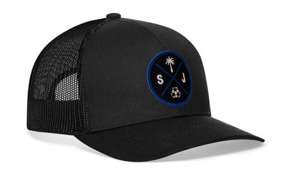 black trucker hat viewed from the right side, showcasing a bold black and blue embroidered X patch prominently displayed on the front