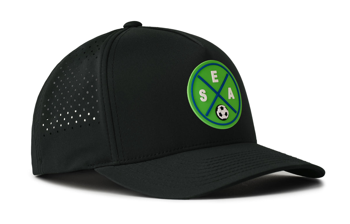 black performance 5-panel hat viewed from the right side, showcasing a bold green and blue pvc patch prominently displayed on the front