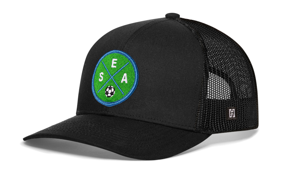 Seattle Soccer Trucker Hat, black snapback showing Haka brandmark on left side of cap.