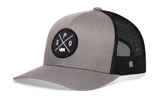 Spokane Trucker Hat, gray-black snapback showing Haka brandmark on left side of cap.