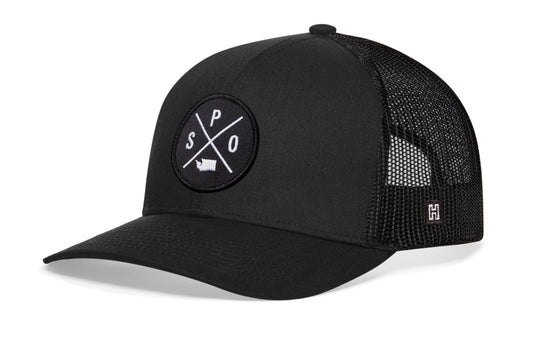 Spokane Trucker Hat, black snapback showing Haka brandmark on left side of cap.