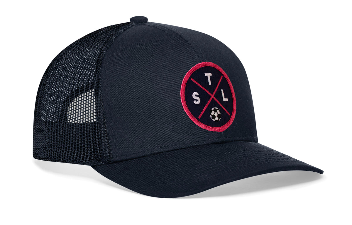navy trucker hat viewed from the right side, showcasing a bold red and blue embroidered X patch prominently displayed on the front
