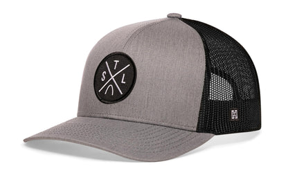 St. Louis Trucker Hat, gray-black snapback showing Haka brandmark on left side of cap.