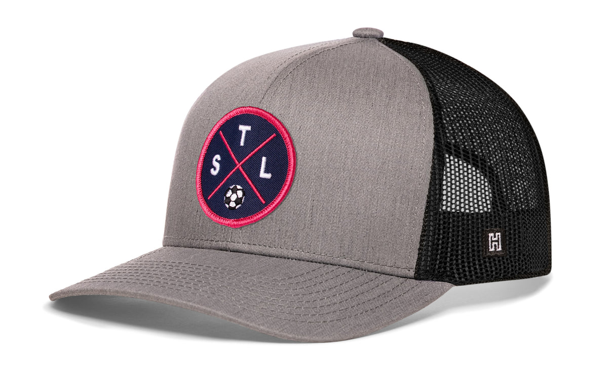 St. Louis Soccer Trucker Hat, gray-black snapback showing Haka brandmark on left side of cap.