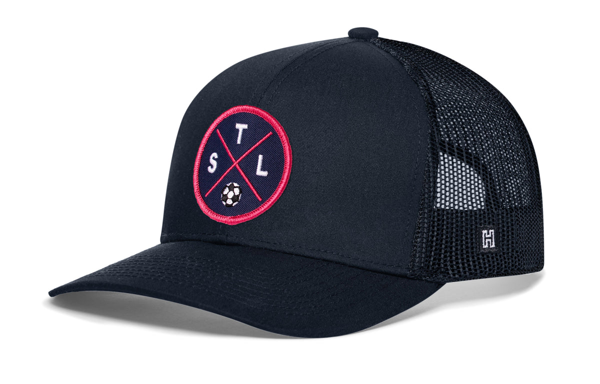 St. Louis Soccer Trucker Hat, navy snapback showing Haka brandmark on left side of cap.