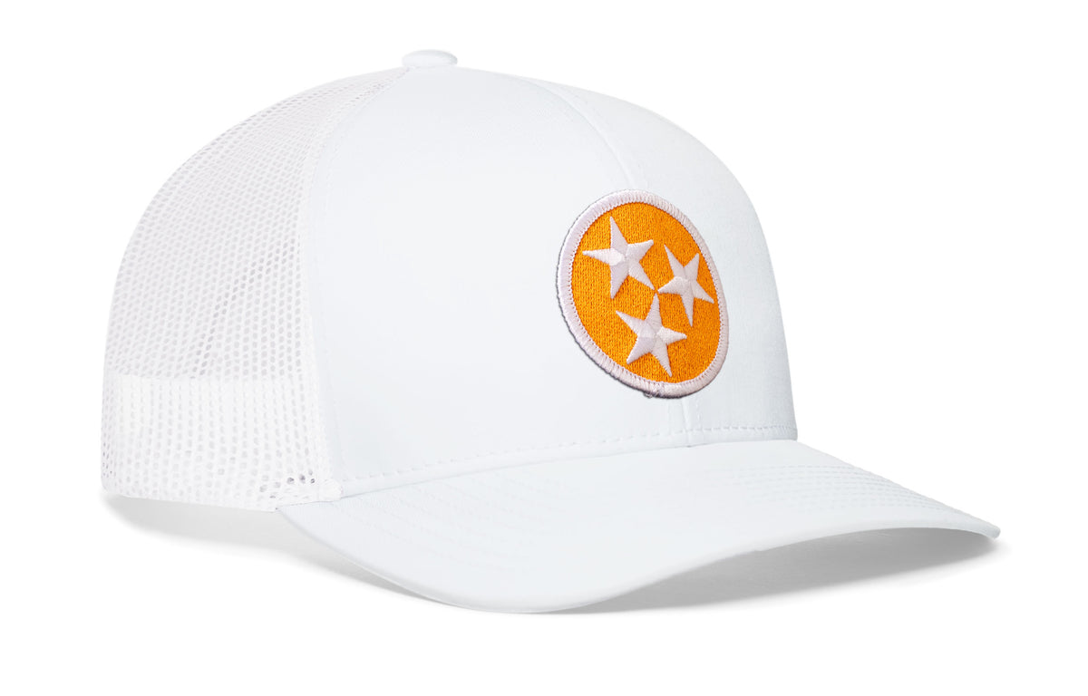 white trucker hat viewed from the right side, showcasing a bold orange and white embroidered flag patch prominently displayed on the front