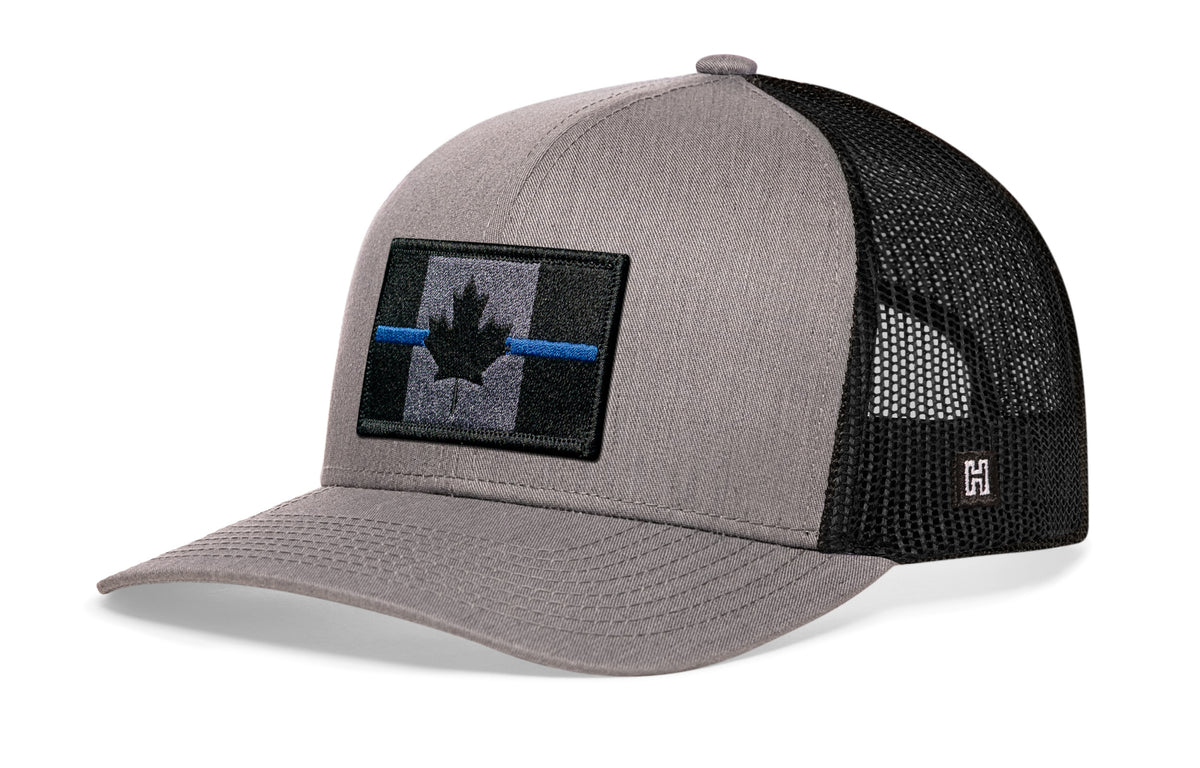 Thin Blue Line Trucker Hat, gray-black snapback showing Haka brandmark on left side mesh with Canadian maple leaf tactical bold blue, gray and black embroidered flag patch.
Show your support for Country and law enforcement.
