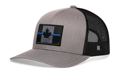 Thin Blue Line Trucker Hat, gray-black snapback showing Haka brandmark on left side mesh with Canadian maple leaf tactical bold blue, gray and black embroidered flag patch.
Show your support for Country and law enforcement.