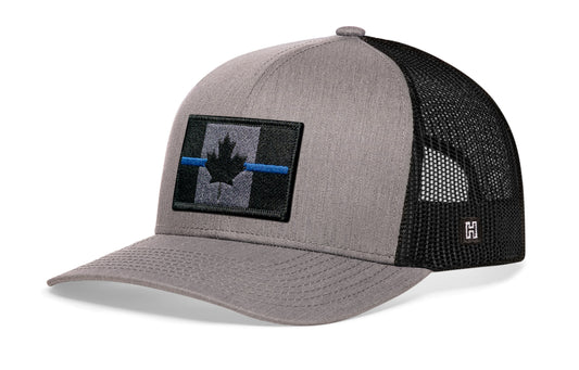 Thin Blue Line Trucker Hat, gray-black snapback showing Haka brandmark on left side mesh with Canadian maple leaf tactical bold blue, gray and black embroidered flag patch.
Show your support for Country and law enforcement.