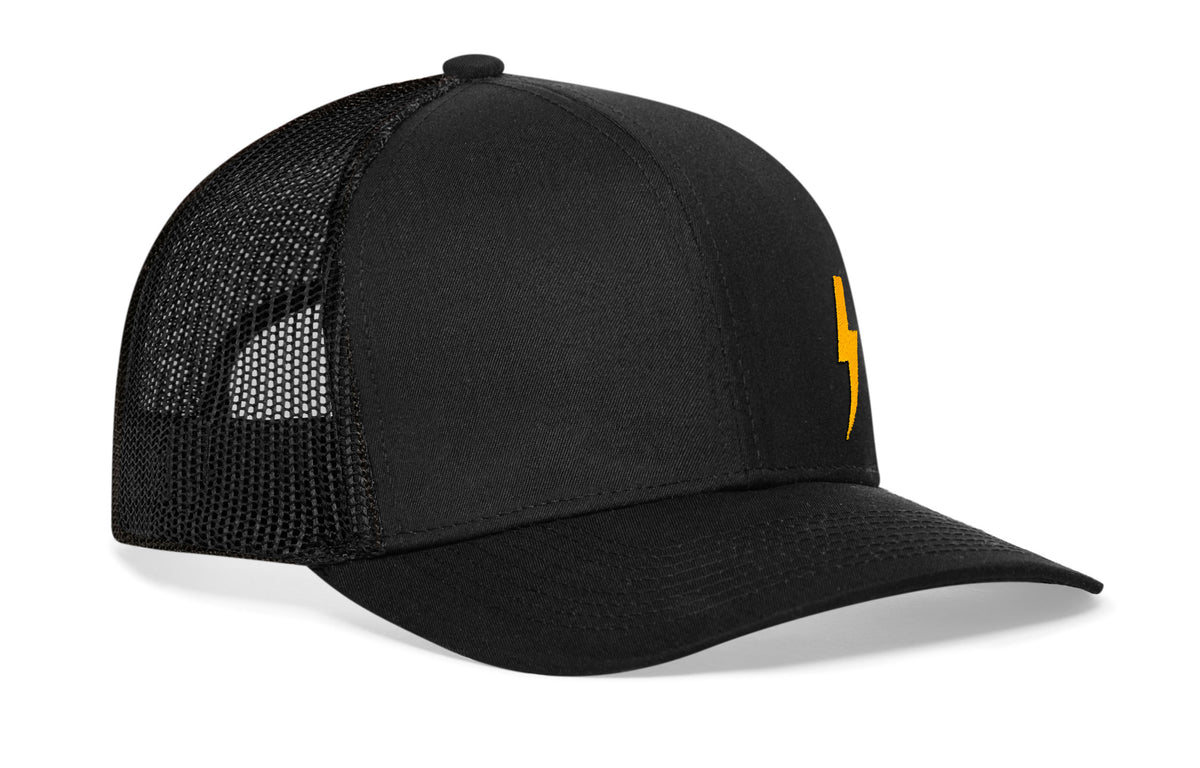 black trucker hat viewed from the right side, showcasing a bold Gold flat embroidery prominently displayed on the front