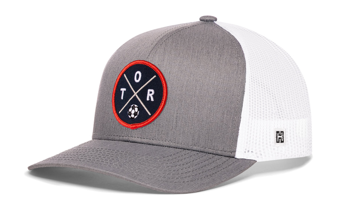 Toronto Soccer Trucker Hat, gray-white snapback showing Haka brandmark on left side of cap.