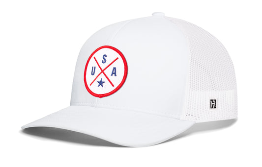 USA X Trucker Hat, white snapback showing Haka brandmark on left side of cap.