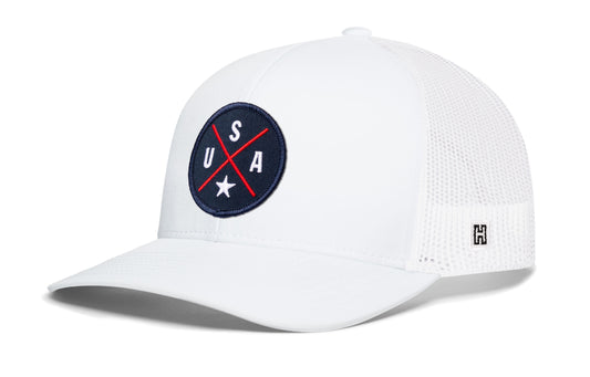 USA X Trucker Hat, white snapback showing Haka brandmark on left side of cap.