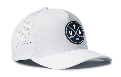 white performance 5-panel hat viewed from the right side, showcasing a bold navy and columbia blue pvc patch prominently displayed on the front
